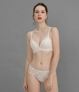 Front view of beige lace lingerie set with deep V-neck and delicate mesh details