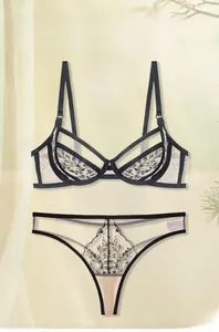 Detail of floral lace embroidery and mesh fabric on elegant black lingerie set
