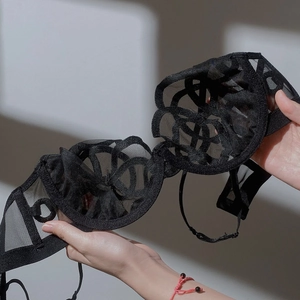 Lace floral black bra with sheer mesh and delicate embroidery in a soft hand-held view