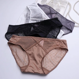 Detail of four colorful French lace panties with cross straps and heart dots patterns