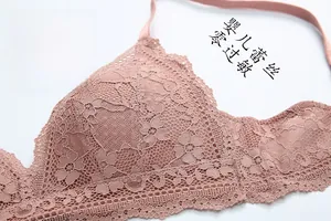 Detail of dusty rose French lace bralette featuring intricate floral patterns and soft fabric