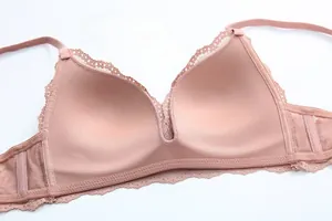 Detail of soft lace wireless bra in dusty pink showing mesh side wings and breathable fabric