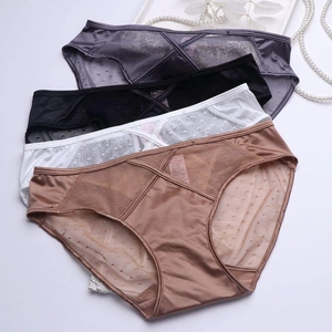 Flat lay of satin lace panties in grey, black, white, and nude with mesh dot details