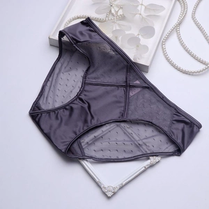 Detail of satin and mesh lace panties featuring cross strap design and elegant pearl decor