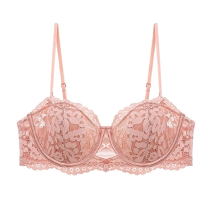 Close-up of peach lace bra with intricate floral embroidery and adjustable thin straps