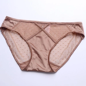 Detailed view of champagne satin fabric with polka dot mesh and cross strap design