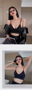Detail of thin shoulder straps and 3D cut black bra paired with a glossy patent jacket