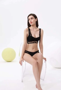Detailed view of sexy black lace lingerie set featuring strappy bra and hollow-out panties