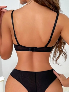 Rear view of black lace lingerie set featuring sheer honeycomb mesh and thin straps