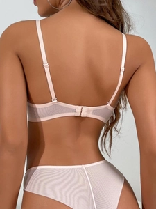 Detail of light pink lace bra back closure with adjustable straps and sheer mesh texture