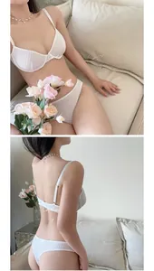 Detailed view of white mesh lace lingerie set on soft sofa with floral accents