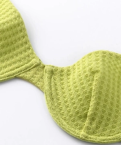 Detailed macro view of the light green waffle knit fabric on breathable lace-free bra