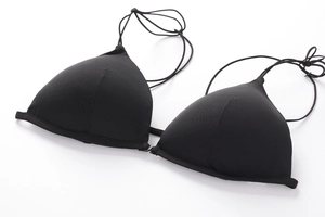 Close-up of black triangle cup bra featuring a front clasp and delicate thin straps
