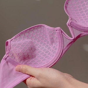 Close-up of pink purple mesh bra cup with honeycomb pattern breathable fabric detail