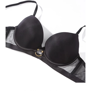 Seamless push up bra in black with mesh wings and golden ring detail on white background