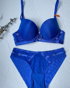 Detail of royal blue push-up bra and mesh panty set with elegant gold ring hardware
