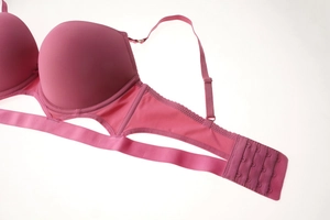 Detail of rose purple push-up bra featuring smooth cups and cutout lace trim details