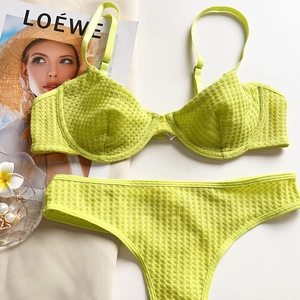 Flat lay of neon green lingerie set featuring honeycomb texture and adjustable straps