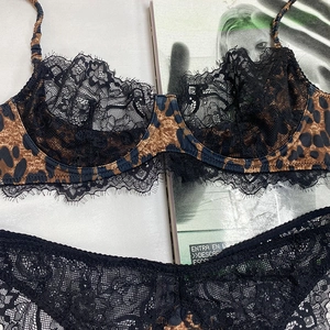 Dettaglio di lingerie leopardata con pizzo nero delicato e coppa del reggiseno con ferretto