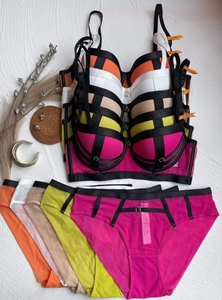Detailed flat lay of push-up bra sets with lace-up straps and contrast color combinations
