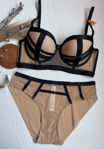 Detailed close-up of nude mesh bra with black strappy geometric lines and 75B size tag