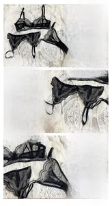 Detail view of sheer black lace lingerie set with elegant floral embroidery and bows