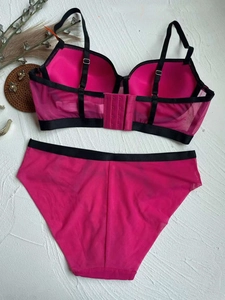 Detail view of pink mesh bra set featuring contrasting black trim and four-row back closure