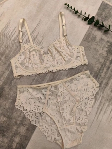 Flat lay of beige floral lace lingerie set with unlined bra and high-waist panty