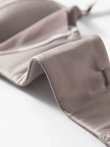 Detail view of the silky microfiber back strap with fine stitching on the strapless bra