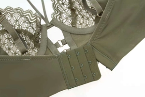 Detail of army green lace lingerie featuring three-row hook closure and adjustable straps