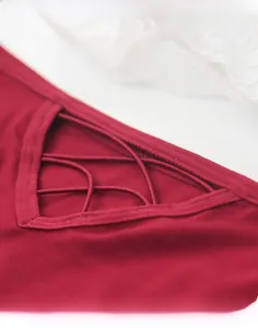 Detail of burgundy low-rise panties featuring a sexy hollow-out criss-cross strap design