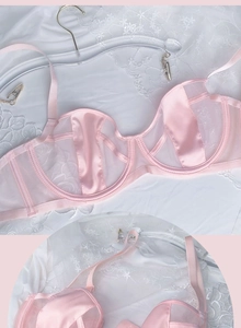 Detail of light pink lace satin bra with mesh stitching and underwire structure