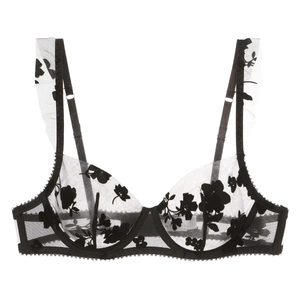 Detail of sheer black mesh bra with floral embroidery and ruffled shoulder straps