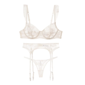 Detailed view of three-piece ivory lace lingerie set with floral embroidery and garter belt