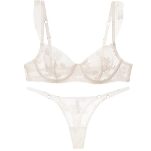 Ivory lace lingerie set with floral embroidery and ruffle straps on white background