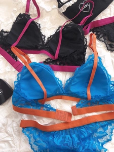 Detail of color-block eyelash lace bralettes with contrast straps and triple back hook
