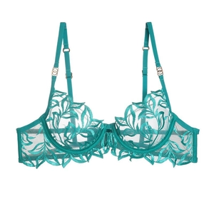 Detailed view of emerald green lace embroidery and sheer floral patterns on underwired bra