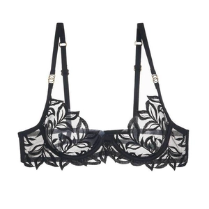 Detail of black lace bra with leaf embroidery and gold adjustable shoulder strap buckles