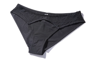 Detail view of black sheer mesh panties with fishnet cutout design and elastic waist
