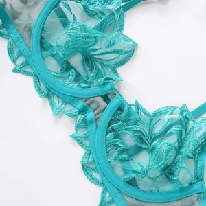 Close-up of turquoise floral embroidery lace and translucent mesh on underwired bra cup