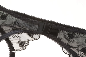 Detail of black heart lace garter belt with secure double hook and eye closure