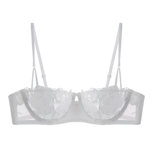 Detail of white lace bra with rose embroidery and mesh fabric showing high craftsmanship