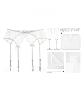 Detail of white floral lace garter belt featuring satin bows and adjustable straps