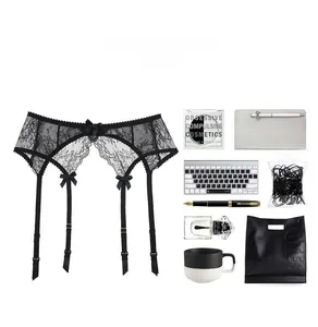Detail of black floral lace garter belt with elegant bows and four adjustable straps