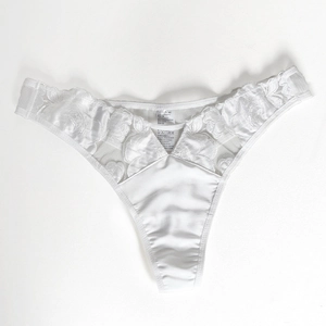 Detail of white satin and floral lace thong with embroidered texture and size label