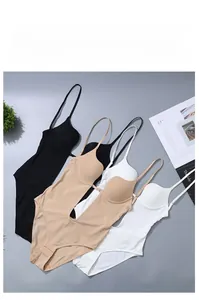 Detailed flat lay of three slimming bodysuits in black, beige and white with thin straps