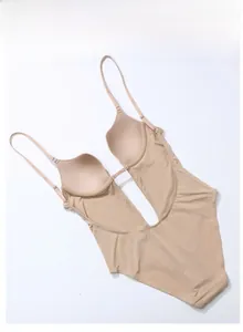 Deep V backless shapewear bodysuit in beige with thin straps and integrated pads