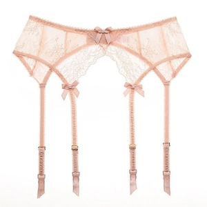 Pale pink lace garter belt with floral embroidery and satin bows on a white background