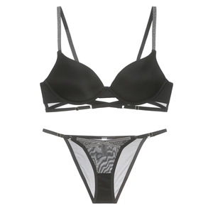 Close-up of black lingerie set featuring rhinestone straps and sheer mesh details