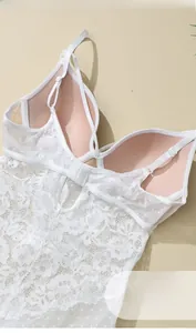 Detail view of white lace bodysuit featuring soft underwire and petal pattern texture